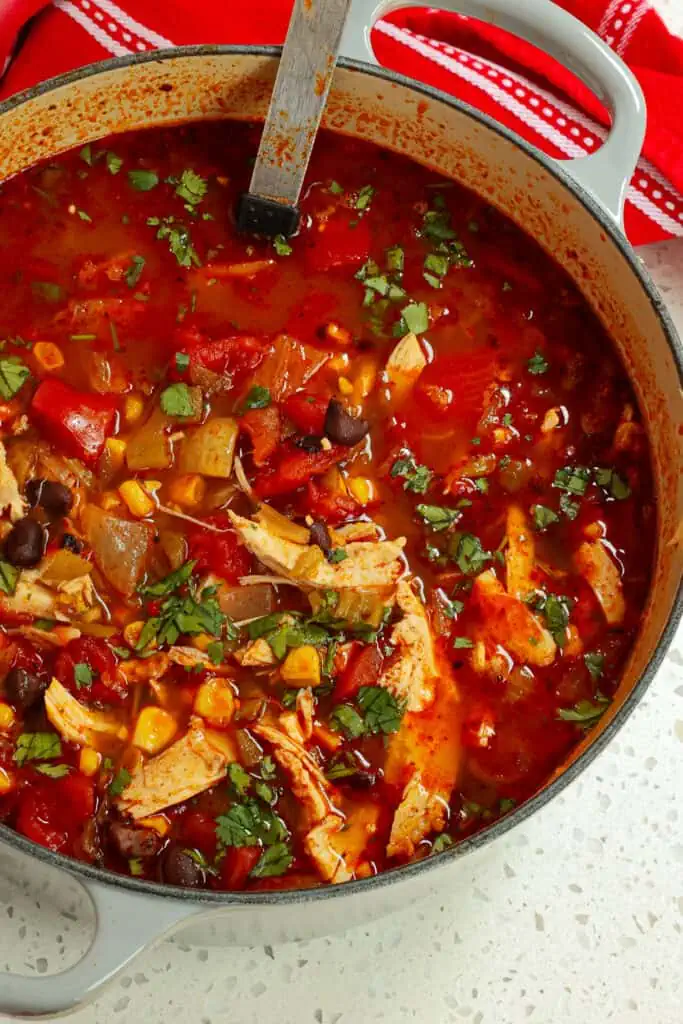 This delectable quick and easy Chicken Taco Soup is bursting with flavors from tender chicken corn, black beans, fire-roasted tomatoes, and green chiles.
