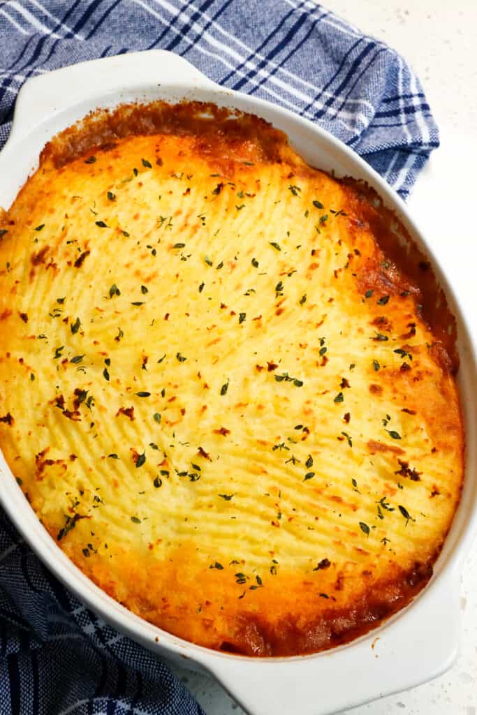 Delicious Cottage Pie is made with ground beef, yellow onion, carrots, and celery in rich brown gravy and topped with creamy cheddar mashed potatoes.