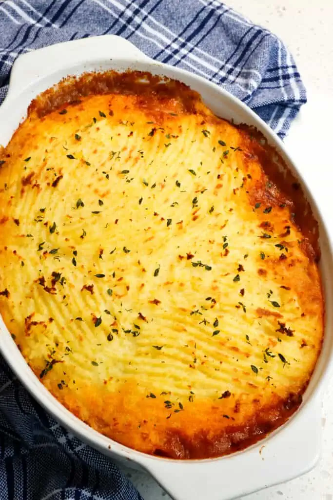 Delicious Cottage Pie is made with ground beef, yellow onion, carrots, and celery in rich brown gravy and topped with creamy cheddar mashed potatoes. 