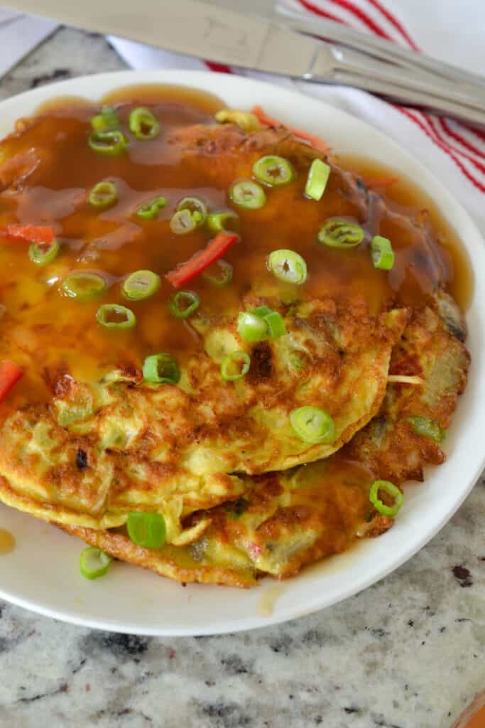 Egg foo Young is a light airy Chinese omelette filled with peppers, celery, mushrooms, onions, bean sprouts, and chicken.  