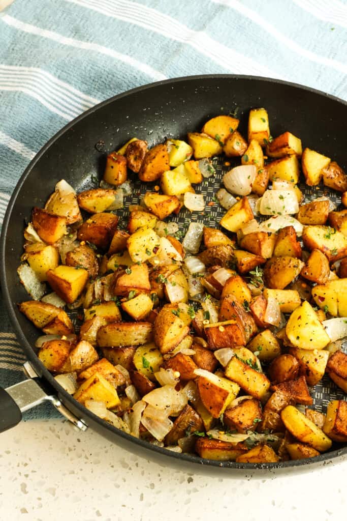 Home Fries are cubed potatoes that are pan-fried crispy on the outside, smooth and creamy on the inside, and seasoned simply with common pantry spices and seasonings.