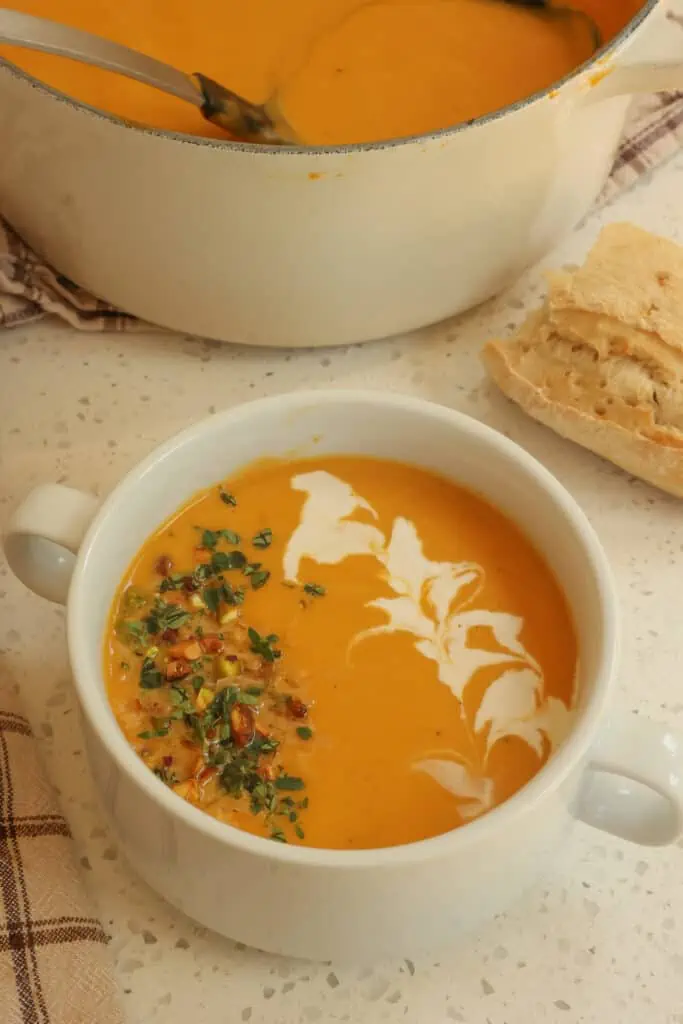 Smooth and creamy Sweet Potato Soup is quick and easy to make. With hints of ginger, cumin, and paprika and topped with toasted coconut flakes and chopped pistachios it is so full of flavor and texture.