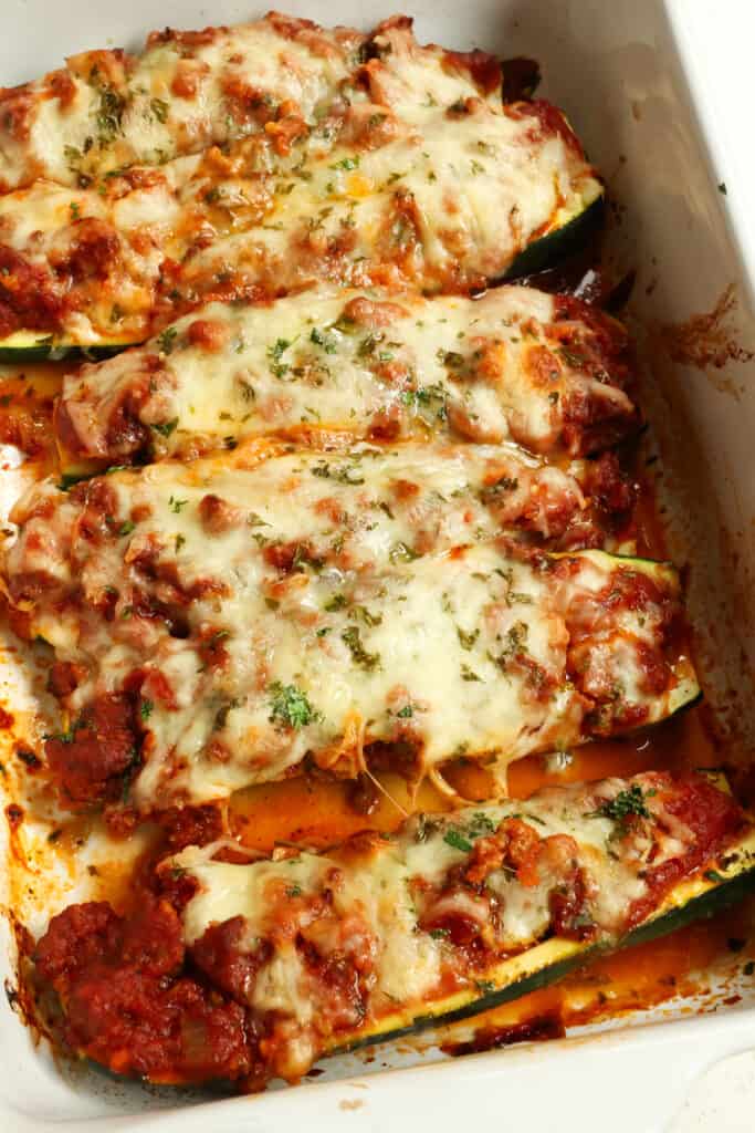 Zucchini Boats are delicious and easy to make with Italian Sausage, onions, garlic, and marinara under a generous blanket of mozzarella cheese and baked until the cheese is melted and the zucchini is tender. 