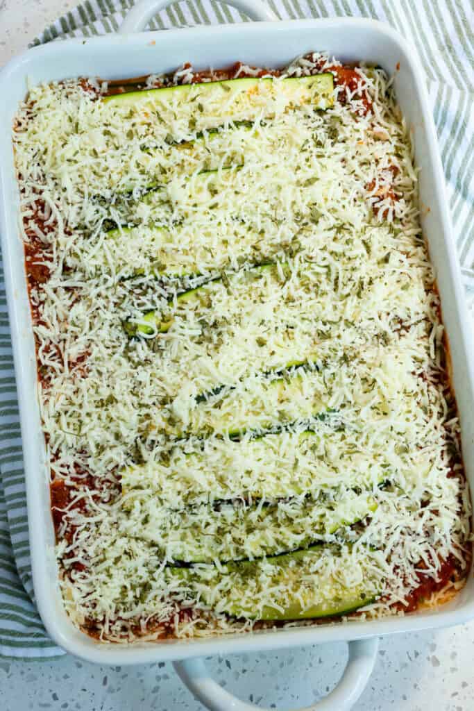  Add another layer of zucchini slices and sprinkle with the remaining mozzarella and a sprinkle of Italian Seasoning. 
