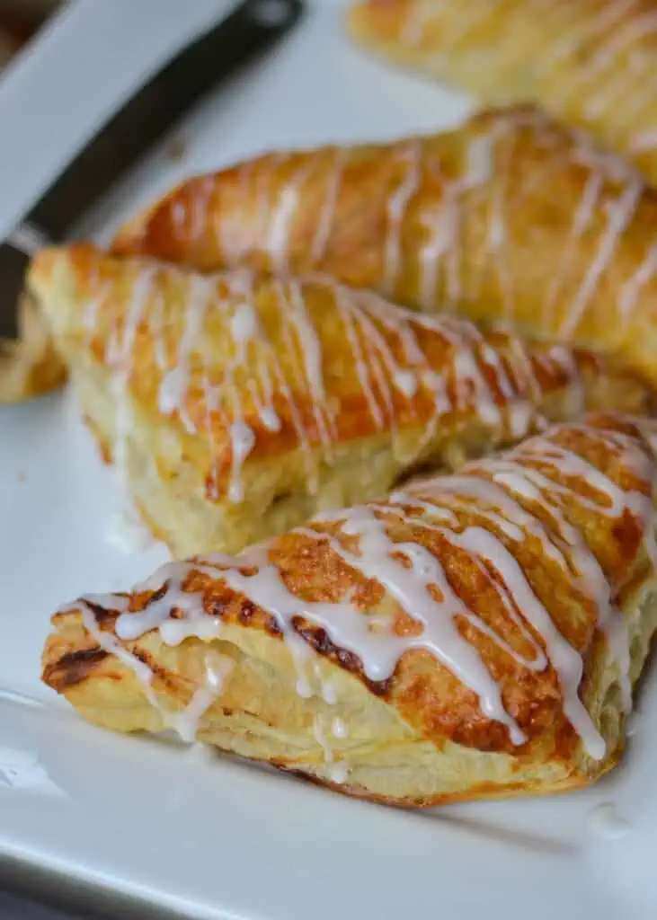 These scrumptious Easy Apple Turnovers are plump full of juicy honey-crisp apples, cinnamon, nutmeg, and cloves and baked in a flaky crust.