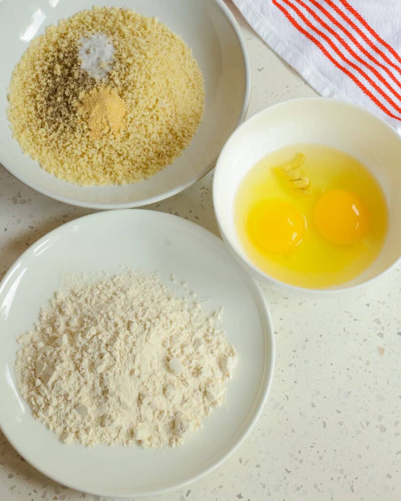 Breading station setup for chicken schnitzel. 
