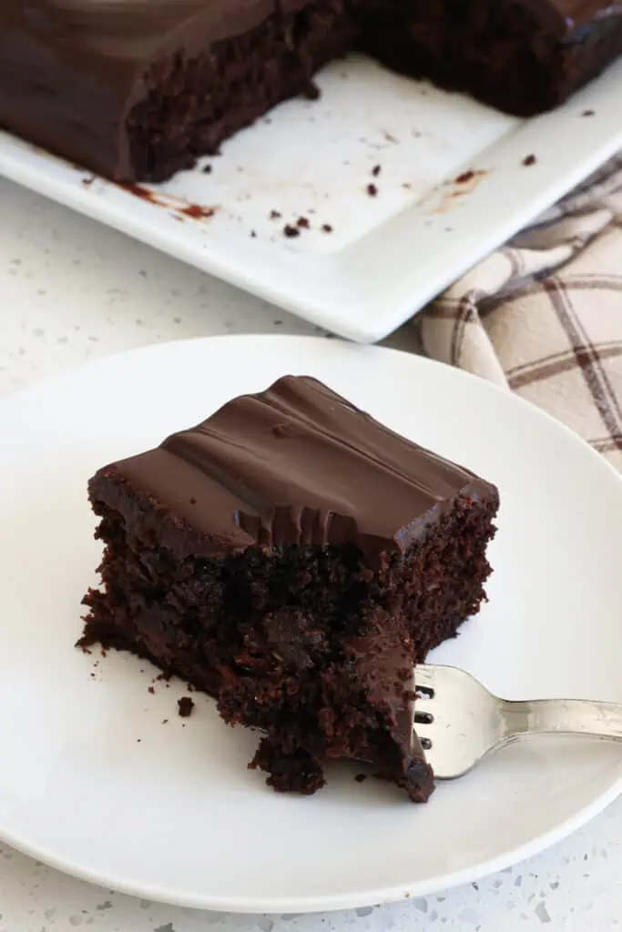 This Chocolate Zucchini Cake is a chocolate lover's dream come true with a moist cake with tons of rich chocolate flavor, semi-sweet chocolate chips, and a chocolate ganache glaze.