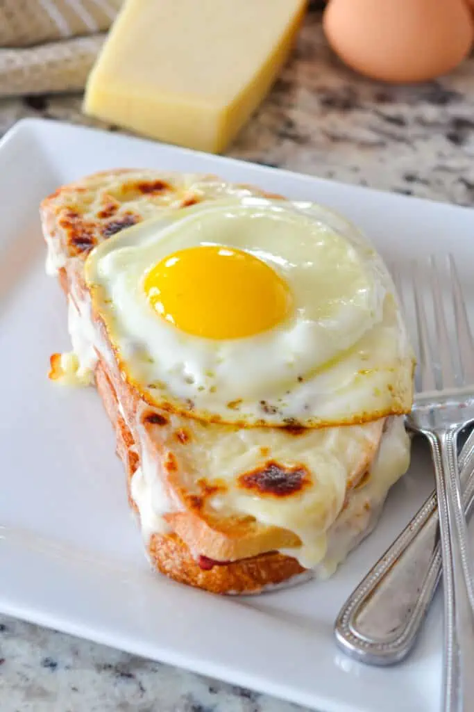 This classic Croque Madame is a highly sophisticated grilled cheese sandwich filled with ham, and creamy Mornay sauce and topped with a sunny-side-up egg. 