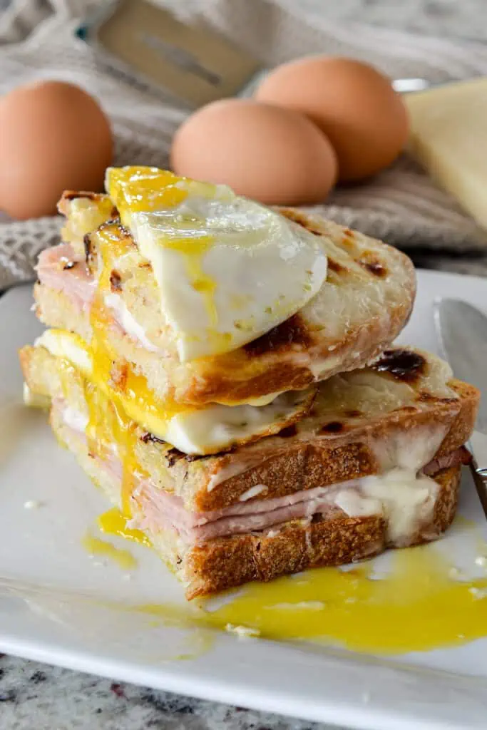 Croque Madame is composed of crisp bread, Mornay sauce, ham, cheese, and a delicious fried egg