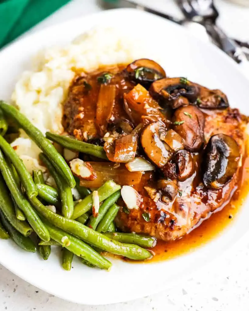 This mouthwatering good cube steak recipe is lightly breaded pan fried cube steaks smothered in an easy mushroom onion gravy.  