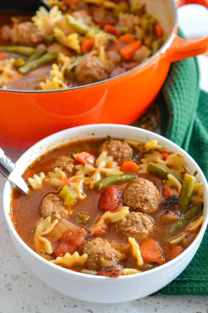 This delicious Meatball Soup Recipe brings meatballs and pasta together with onions, carrots, celery, and green beans in a hearty beef broth that has been perfectly seasoned with Italian spices.