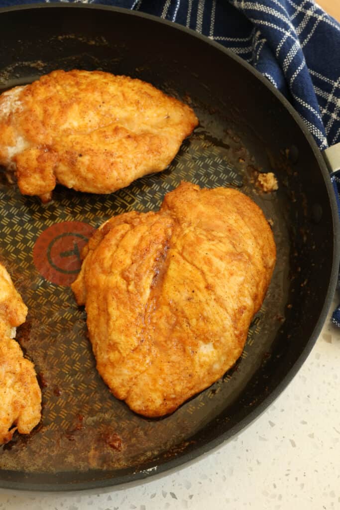 Add the chicken breast and cook until golden brown on the bottom, then flip and cook until the other side is golden brown and the chicken is cooked through.