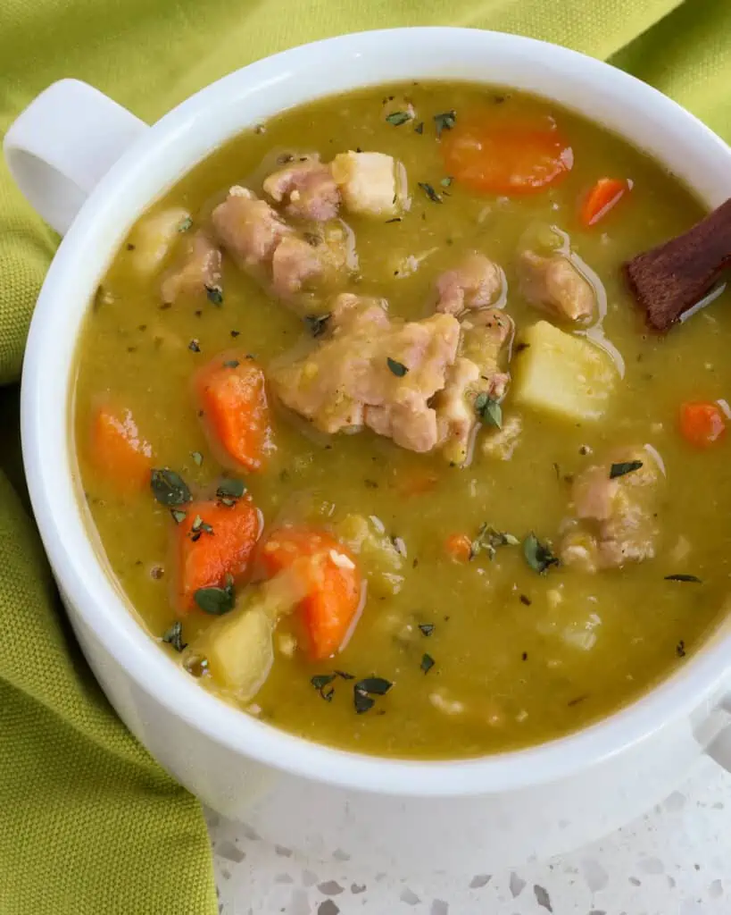 This delicious Split Pea Soup Recipe combines onions, celery, carrots, potatoes, and ham into a smooth, creamy split pea and chicken broth base that has been lightly seasoned with marjoram and thyme.