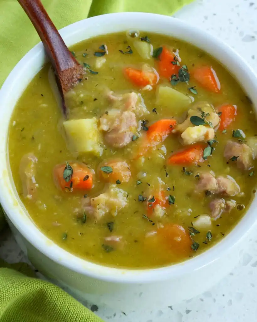 Split Pea Soup Recipe combines onions, celery, carrots, potatoes, and ham into a smooth, creamy split pea base that is lightly seasoned.  