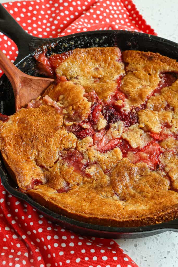 An easy Strawberry Cobbler made with fresh strawberries and a buttery biscuit topping made with buttermilk. For an over-the-top taste sensation, enjoy a la mode or with fresh whipped cream.