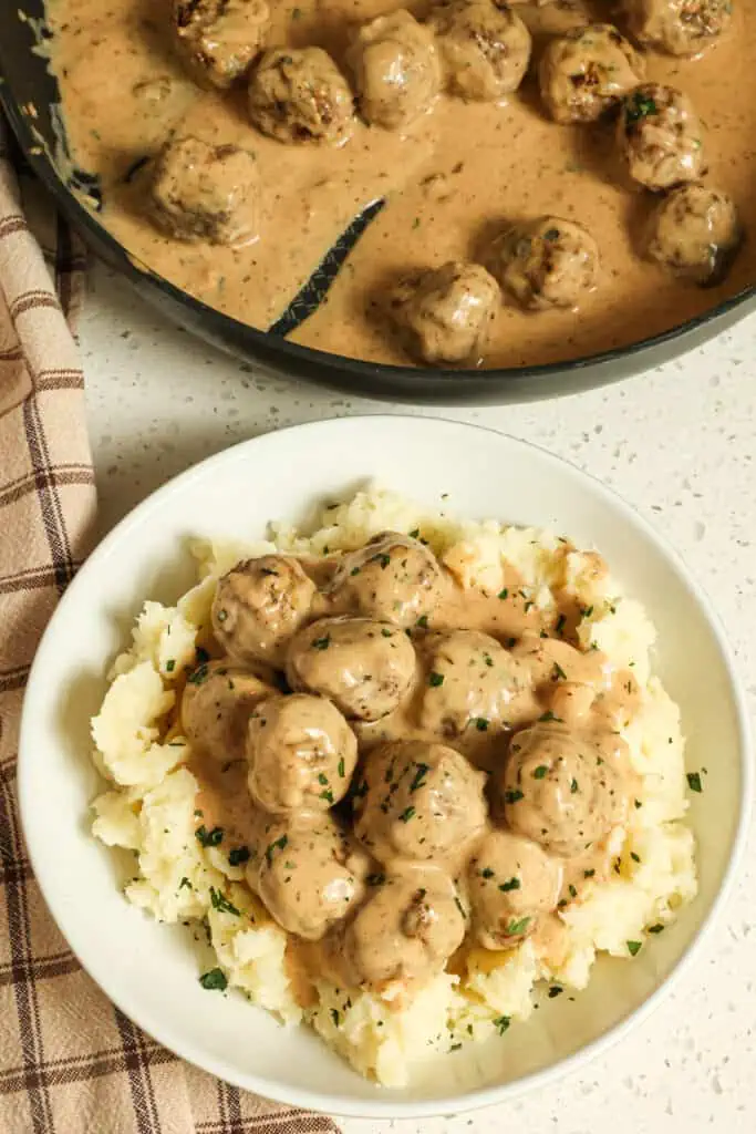 Tender Swedish Meatballs with hints of allspice and nutmeg are smothered in a rich and creamy gravy. These are a must-make and easy enough for a weeknight dinner. 