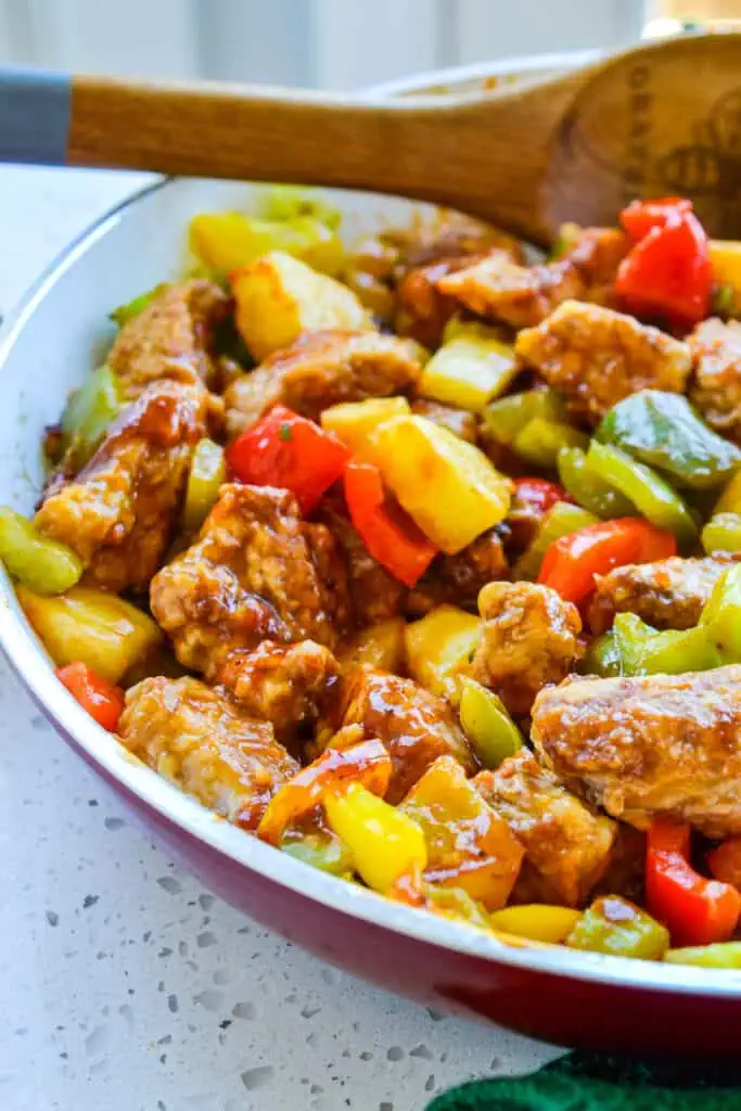 Crispy breaded pan fried pork tenderloin bites combined with sweet bell peppers and pineapple in a ginger Asian sauce.