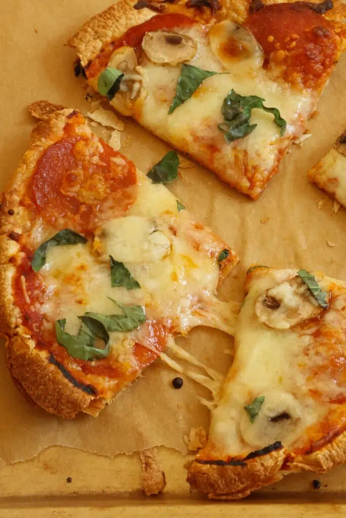 Super easy and crispy Tortilla Pizzas made in less than 15 minutes and easily customizable to suit everyone's taste. 