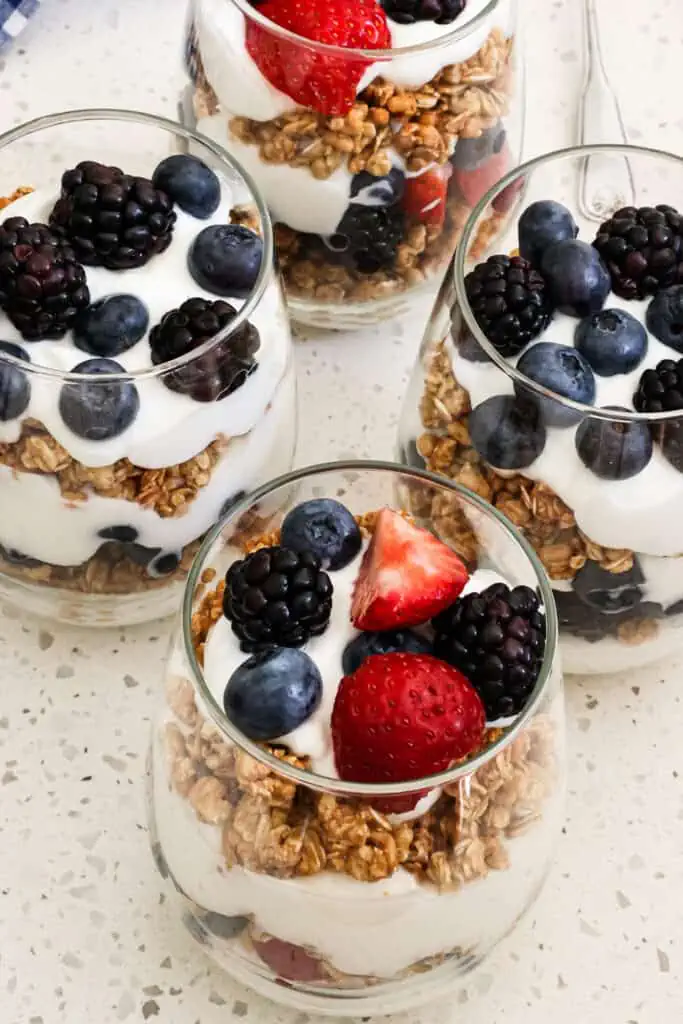 Quick and easy Yogurt Parfaits are filled with layers of creamy vanilla yogurt, crunchy granola, and fresh berries.