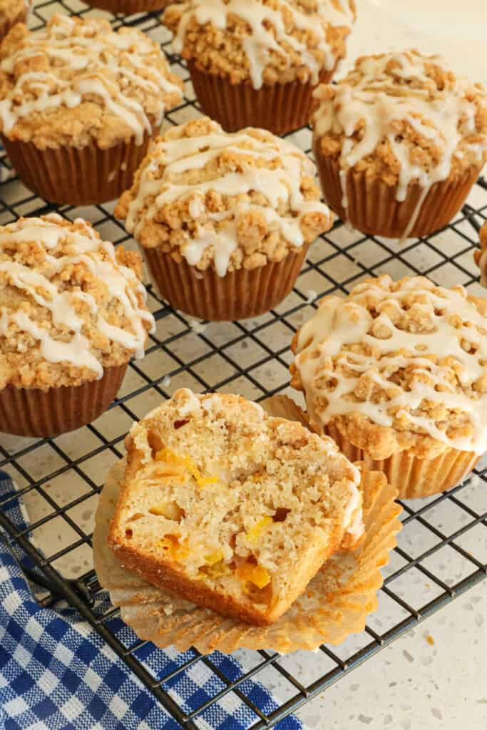 Moist and easy bakery-style Peach Muffins with a mile-high crumb topping and a maple vanilla drizzle. Bake a batch today and freeze half for later in the month for on-the-go breakfasts. 