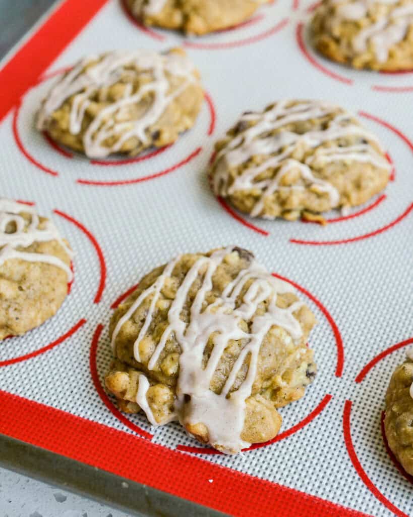 Apple cookies on a silicone baking mat.