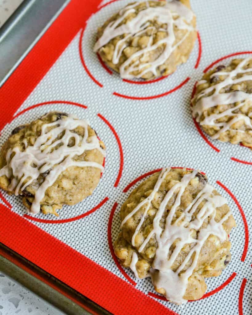 An overhead view of apple cookies drizzled with cinnamon glaze.