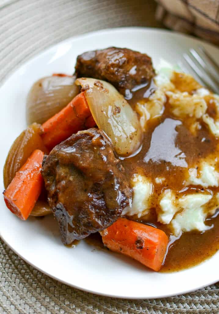 These Beef Short Ribs are slowly cooked and perfectly seasoned braised beef short ribs, carrots, and onions in a broth that becomes an awesome gravy