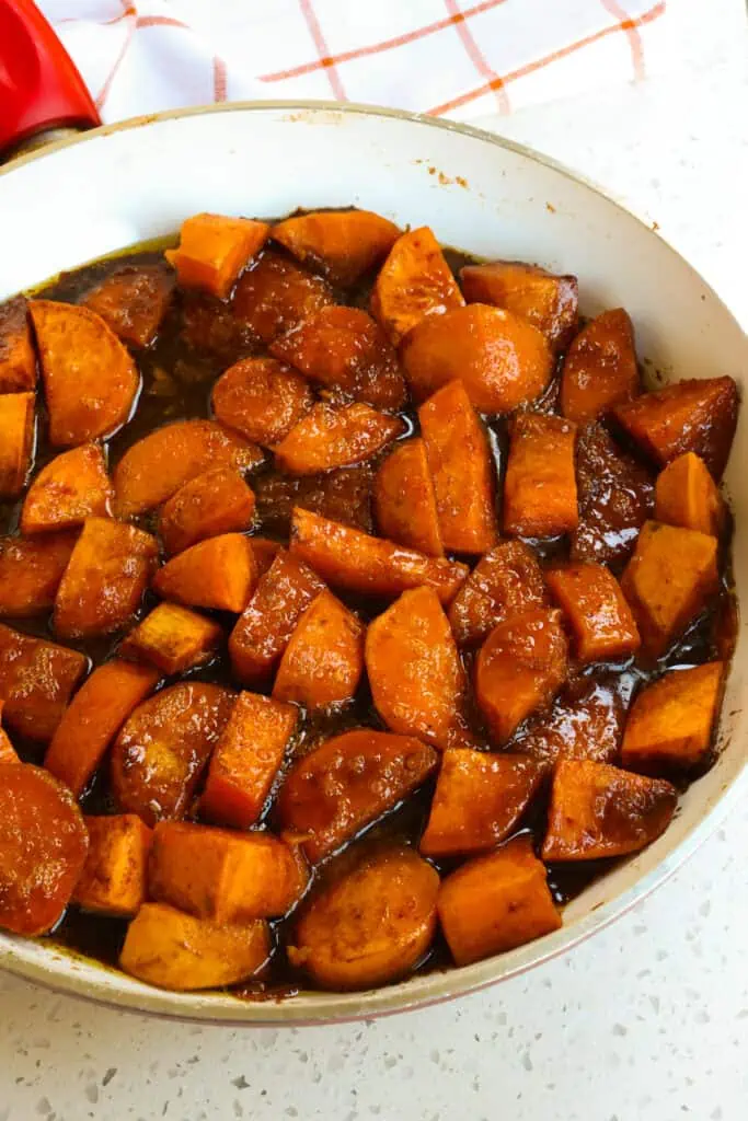 These tasty Southern-style Candied Yams are made in one easy skillet with a buttery brown sugar cinnamon nutmeg glaze.