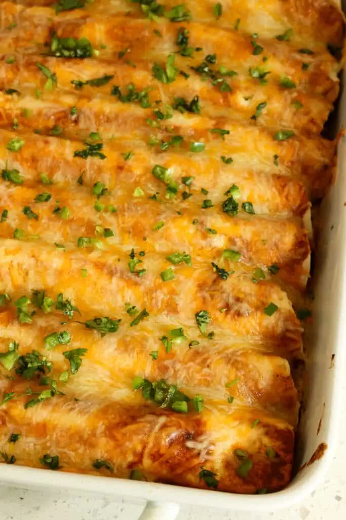 This chicken enchilada recipe is a true flavor explosion with green chilis, homemade enchiladas sauce, and a Mexican cheese blend. No dull bland flavors here.