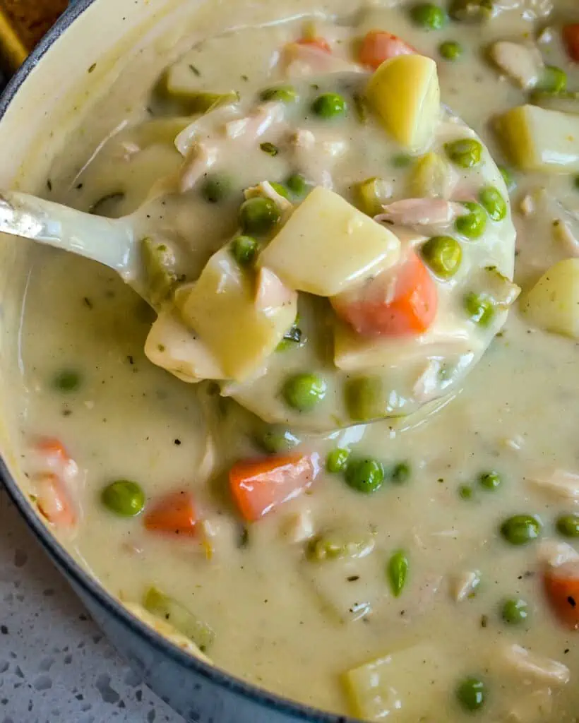 Chicken Pot Pie Soup has all the comforts of the traditional pot pie without the time and hassle of rolling a fresh baked crust. This is comfort food at its best topped with fresh biscuits. 