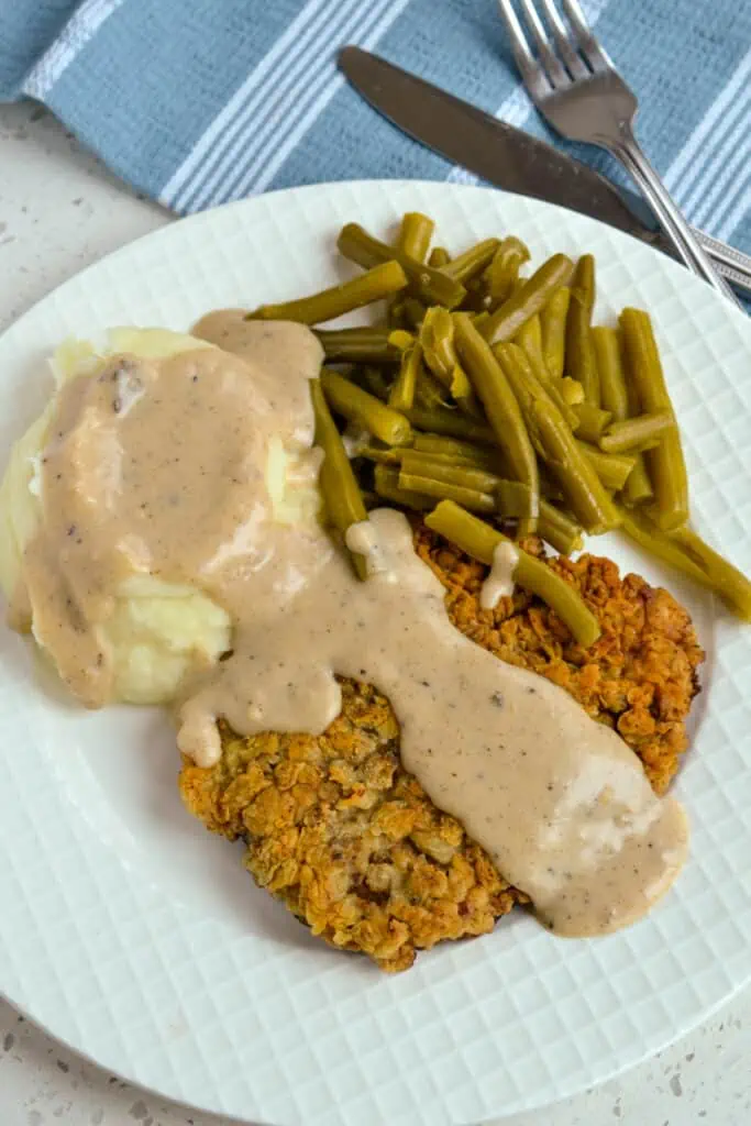 Country fried steak with mashed potatoes and green beans