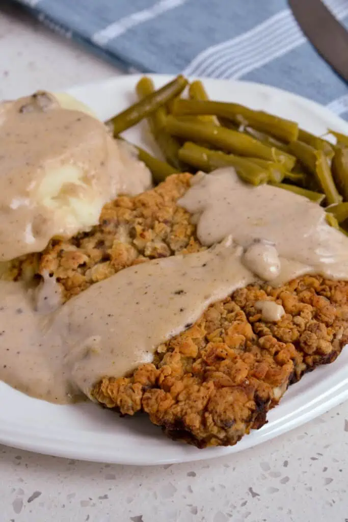 Classic crispy southern chicken fried steak with an easy finger-licking good pan cream gravy made from the drippings.