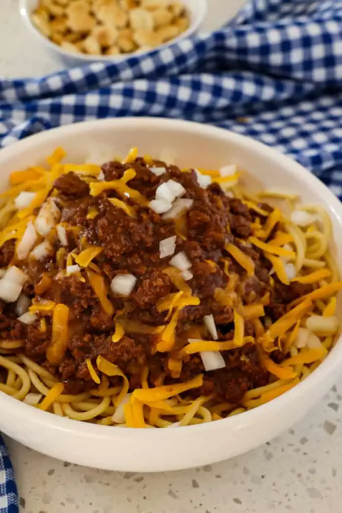 Serve over cooked spaghetti with shredded cheddar and finally diced onions. 