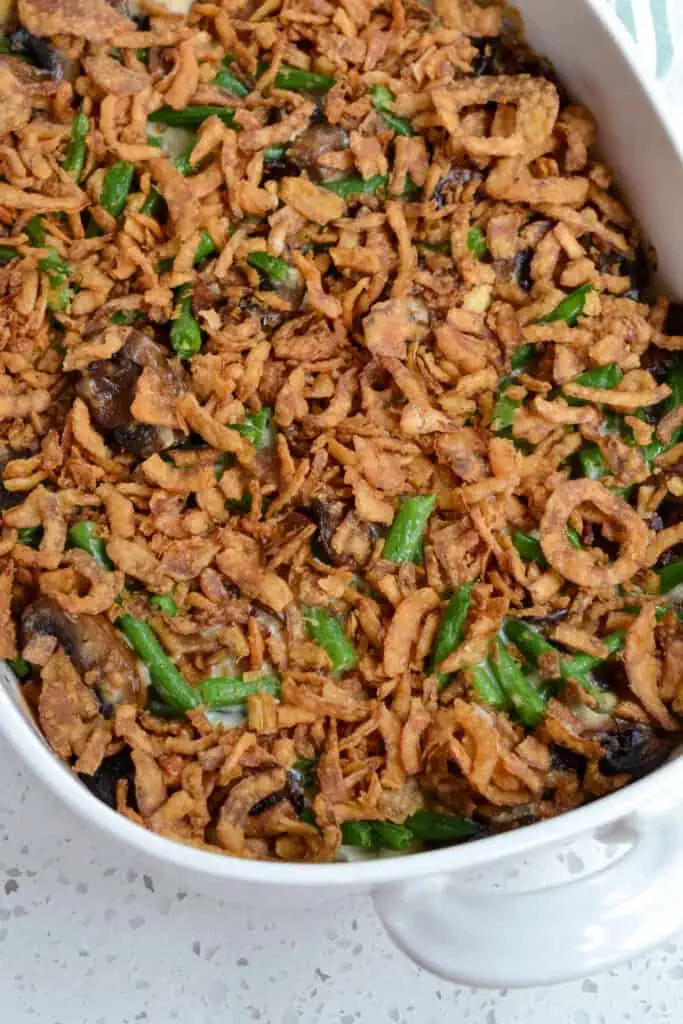 Green bean casserole tastes so much better made with a homemade sauce instead of the typical canned cream of mushroom soup.  We love to serve this classic holiday side dish for Thanksgiving and Christmas.  