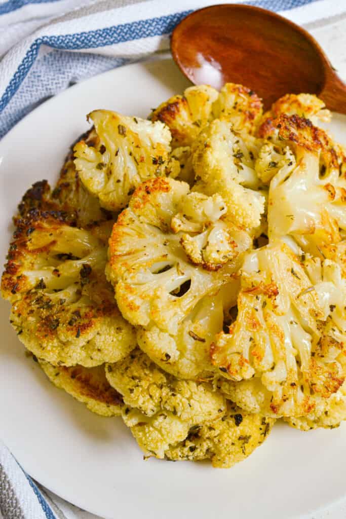 A heart healthy easy roasted cauliflower side dish made with wholesome ingredients like olive oil, Parmesan cheese, dried herbs and spices.