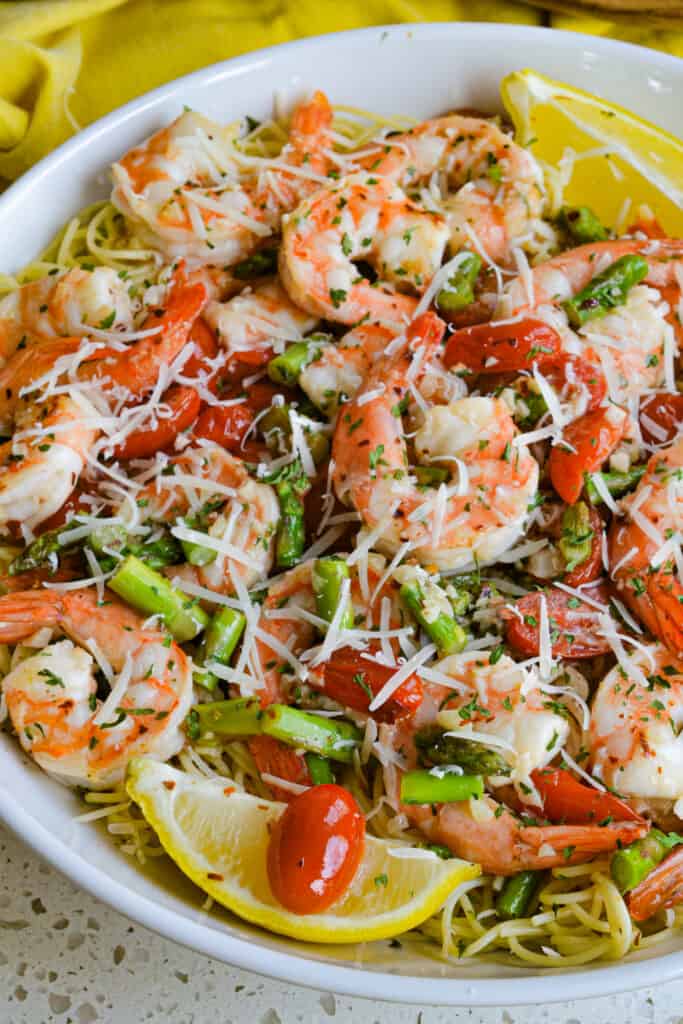 A simple, elegant and easy shrimp scampi recipe with a lemon garlic butter sauce.  It is traditionally served over angel hair pasta or thin spaghetti drizzled with scampi sauce.