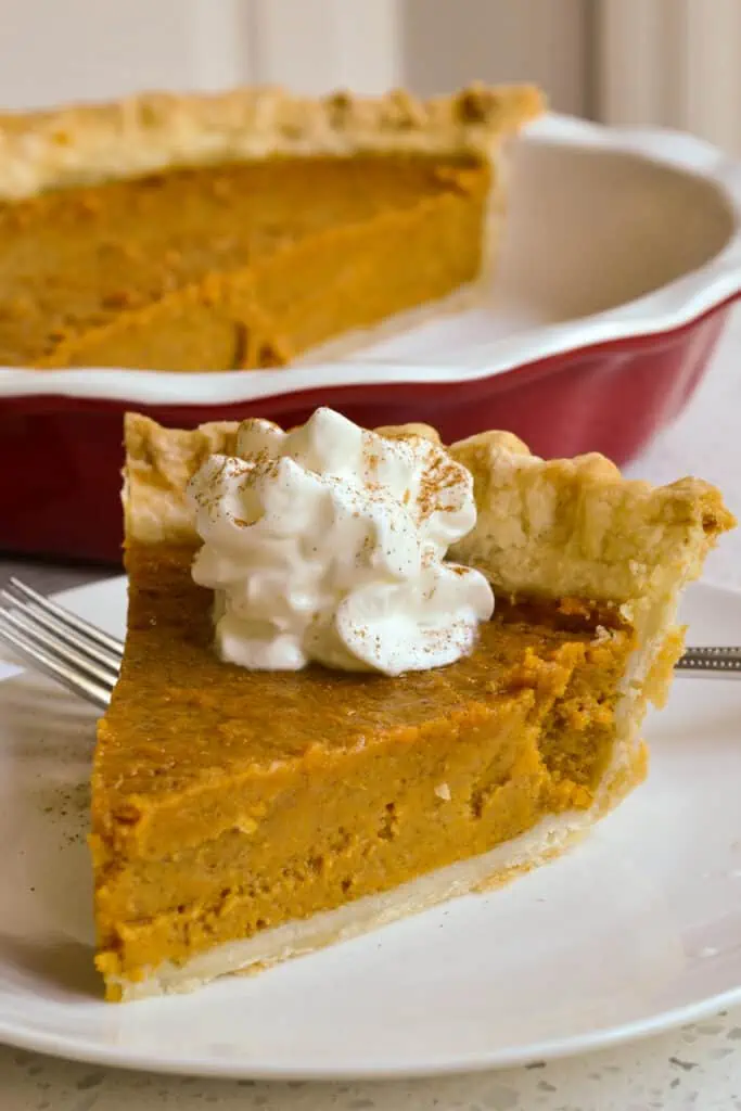 A Southern Sweet Potato Pie made with a flaky buttery crust brimming with a creamy sweet potato filling with cinnamon, ginger, nutmeg, and cloves.