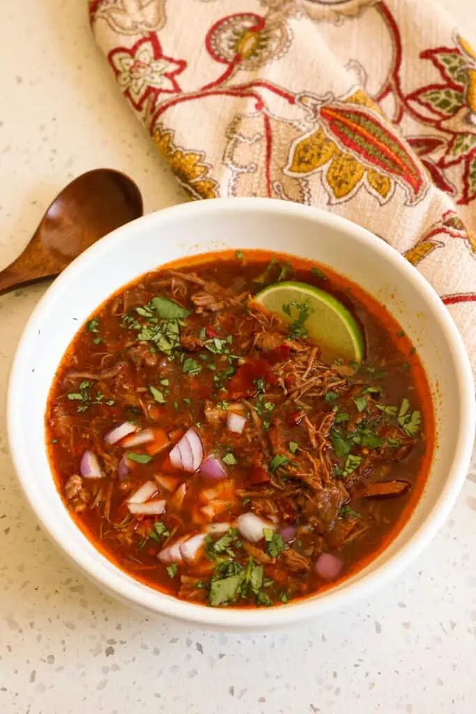 This delicious Beef Birria Recipe is a flavor-packed, slow-cooked beef stew made with chuck roast and short ribs simmered with guajillo chiles, garlic, onions, fire-roasted tomatoes, and fresh cilantro. 