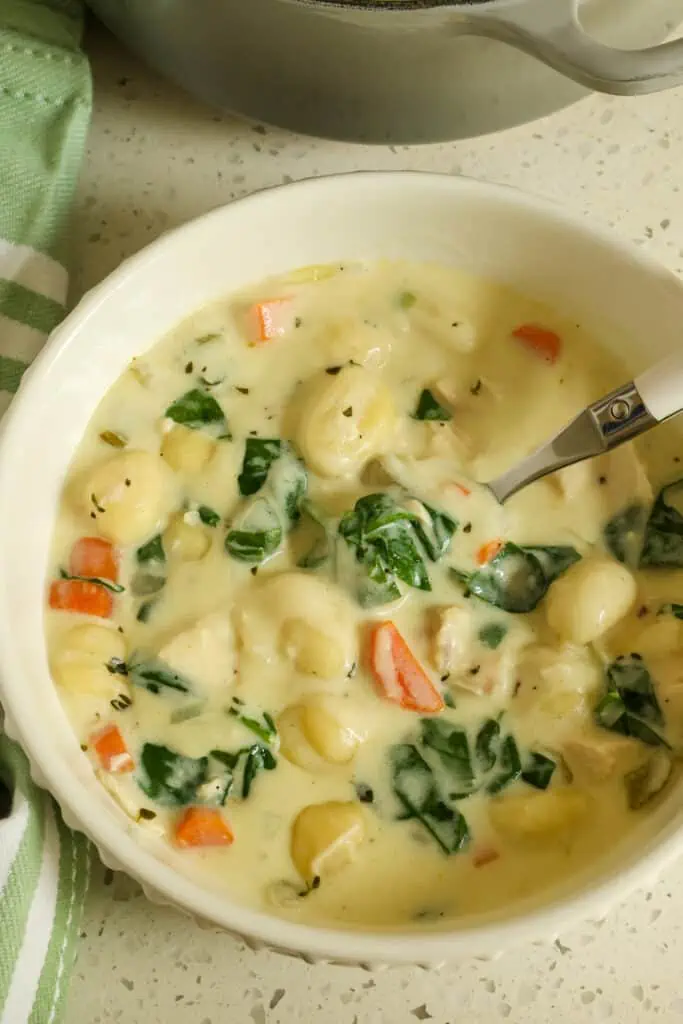Chicken Gnocchi Soup is family-friendly soup that's perfect for a cold winter night. Potato gnocchi, carrots, spinach, and tender chicken in a creamy, seasoned broth.