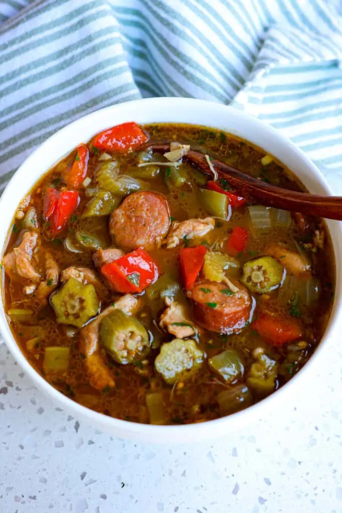 Authentic Louisiana style Chicken and Sausage Gumbo made with spicy andouille sausage, onions, celery, and bell pepper, commonly referred to as the holy trinity, and okra
