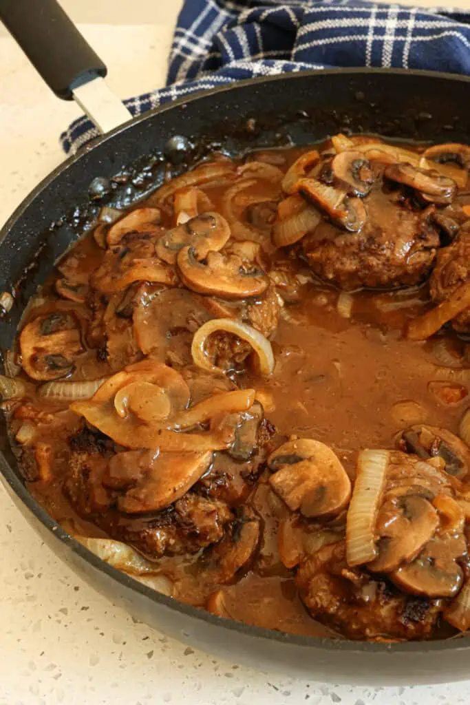 Easy Hamburger Steaks are tender juicy seasoned ground beef patties smothered in a rich beefy gravy with mushrooms and onions. This is the ultimate comfort meal and easy enough for a weeknight.  