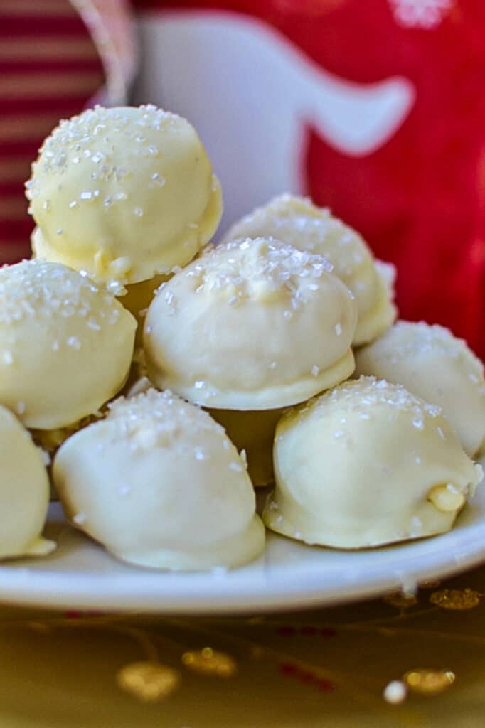 These gorgeous, tasty, and fun Eggnog Truffles are made with prepared eggnog, nutmeg, and rum, all dipped in white chocolate and topped with shimmering sugar.