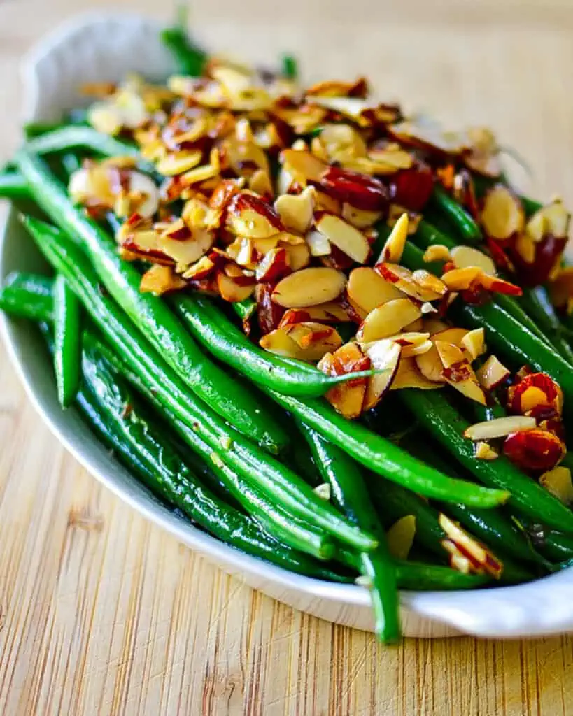 Green Beans Almondine combines French-style green beans, toasted almonds, fresh minced garlic, and fresh lemon juice into an amazing accompaniment for chicken, fish, beef, or pork.