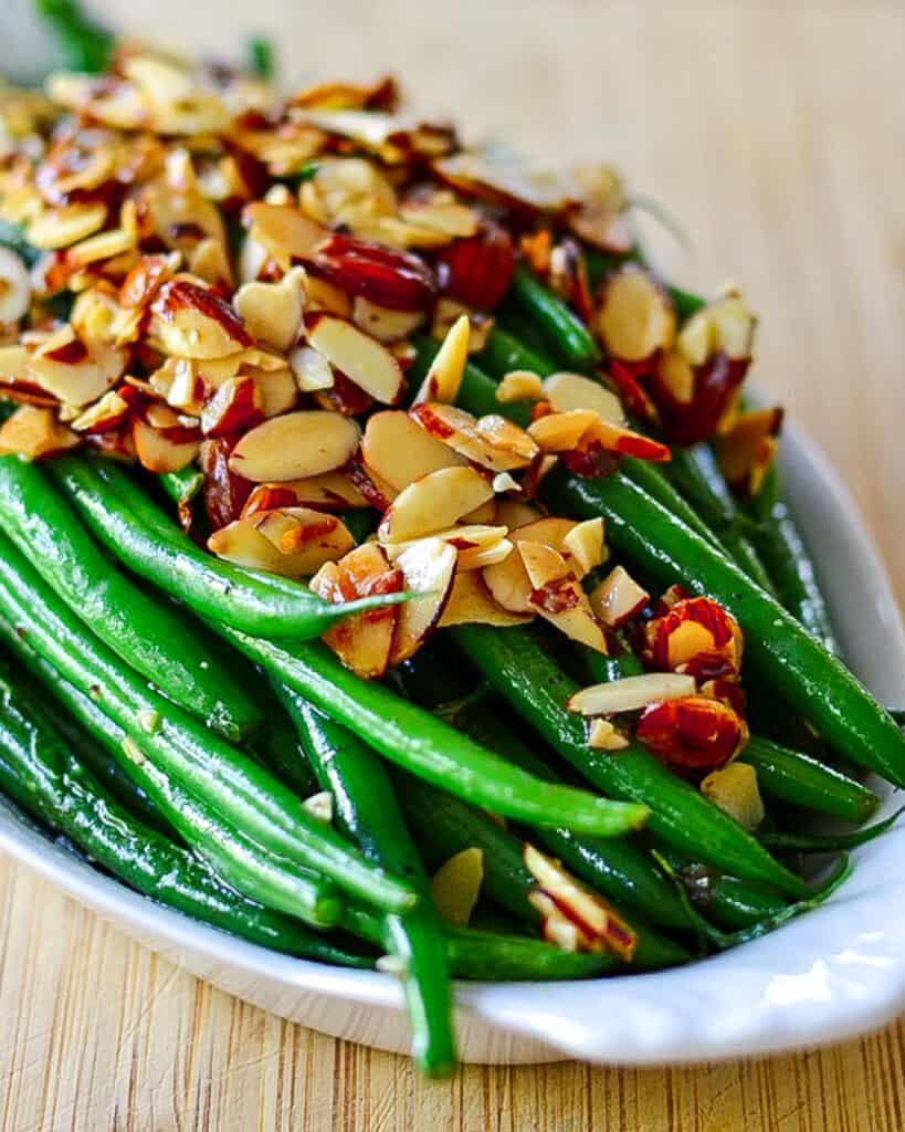 Green beans almondine in a casserole dish.