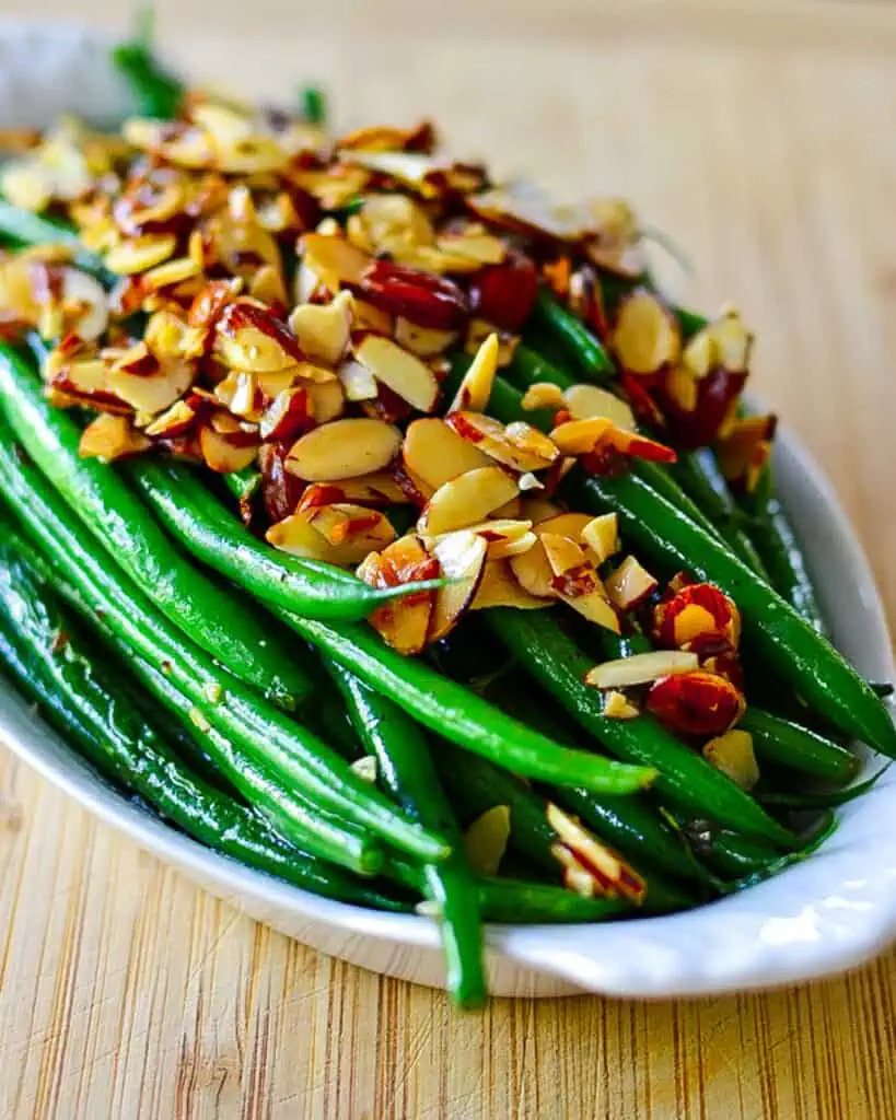 For optimal flavor, use fresh green beans. I like the haricots verts or French-style green beans. They are slightly longer and skinnier than regular green beans. They are harvested earlier and are more tender.