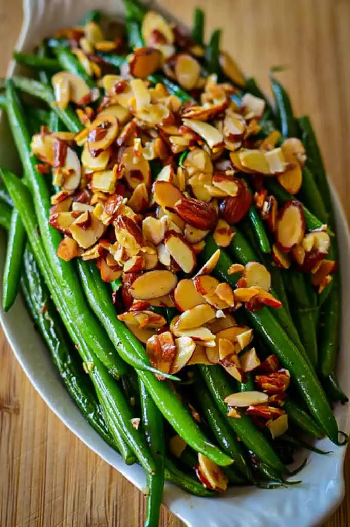 This quick and easy Green Beans Almondine Recipe combines French green beans with toasted almonds, garlic, and little lemon juice for an elegant side dish. 