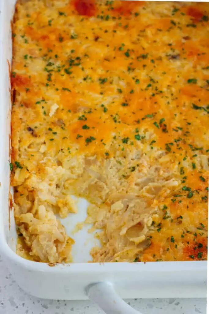 This amazing cheesy shredded Hashbrown Casserole is a cinch to make with shredded frozen hashbrowns, onions, garlic, canned cheddar soup, sour cream, and butter. 