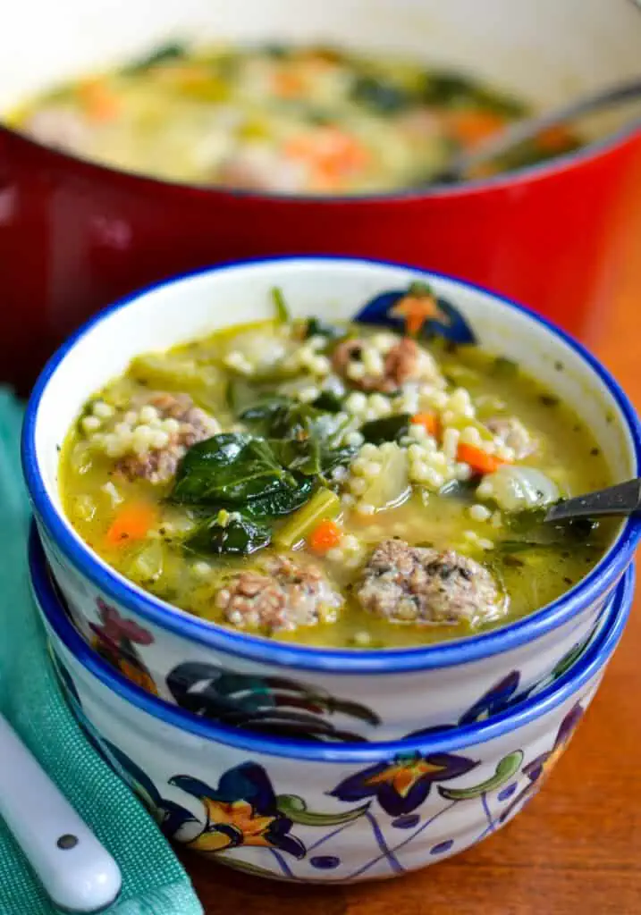 Classic Italian Wedding Soup is made with delicious pork and beef bite-sized meatballs, onions, carrots, celery, garlic, spinach, and pasta in a deliciously seasoned broth. 