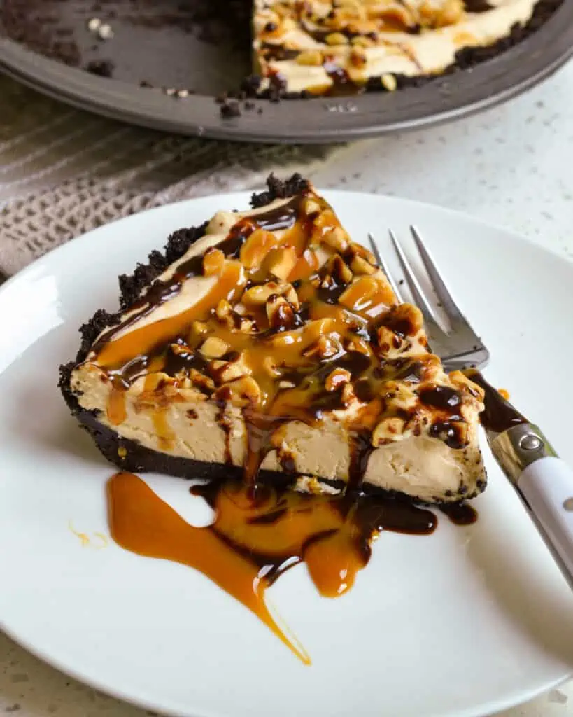 A slice of peanut butter pie on a plate with a fork. 