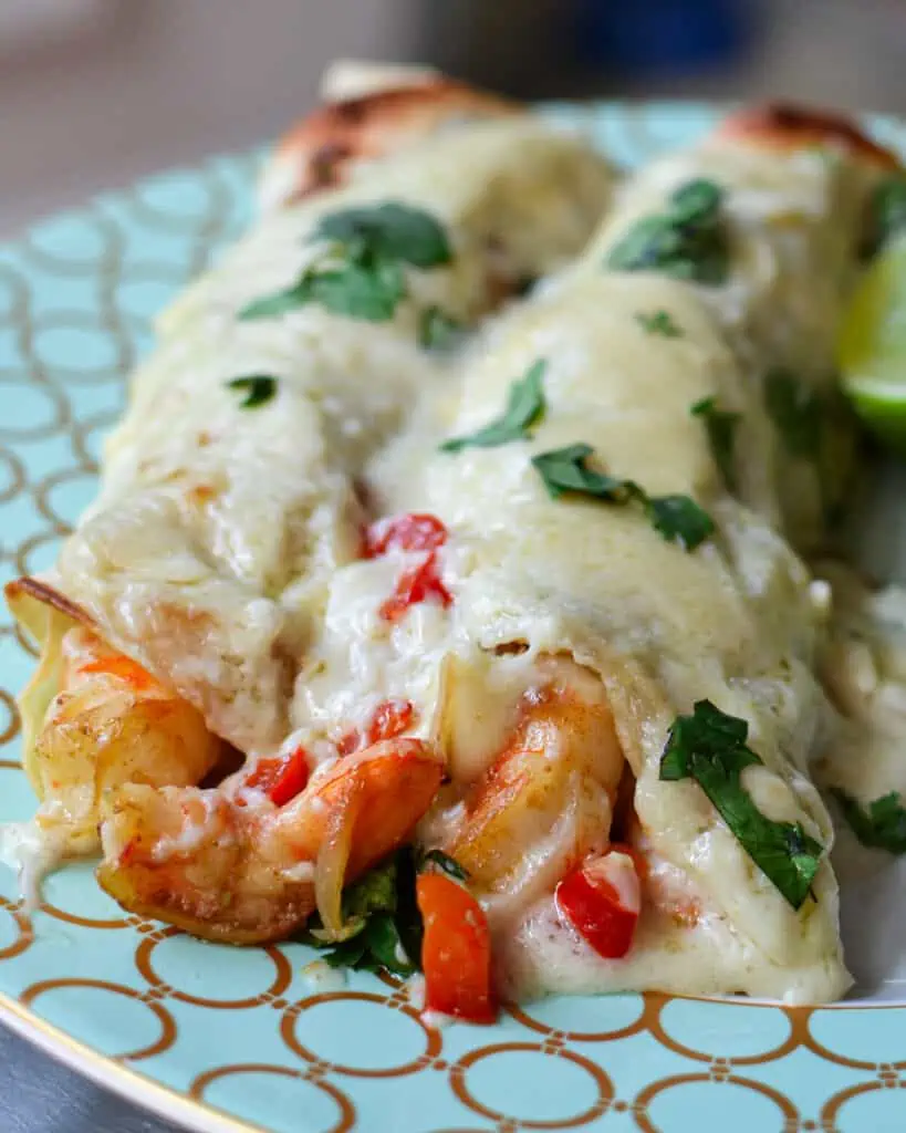 Creamy Shrimp Enchiladas brings together fresh shrimp, shallots, red bell pepper, and garlic, all wrapped up in a creamy Monterrey Jack cheese sauce. 